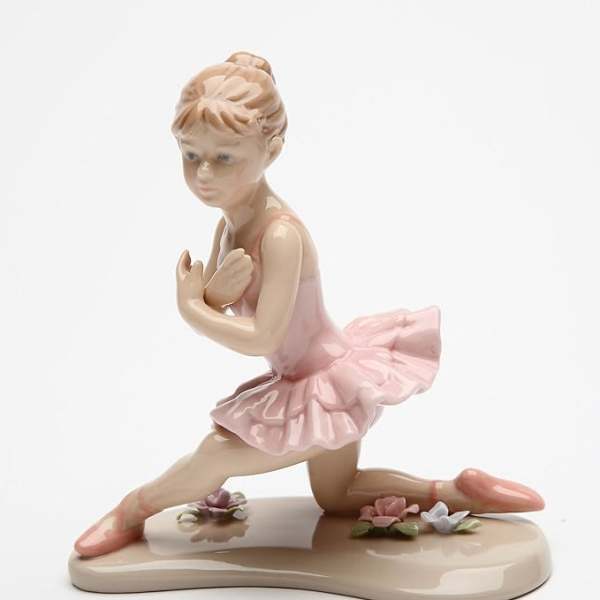 Porcelain ballerina figurine in a pink tutu on a small base