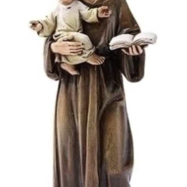 A religious statue of a robed woman holding a child and an open book
