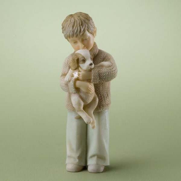 Figurine of a child holding a small dog