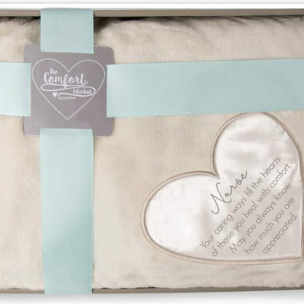 Cream comfort blanket in a gift box with blue ribbon and heart patch printed with a nurse appreciation message.