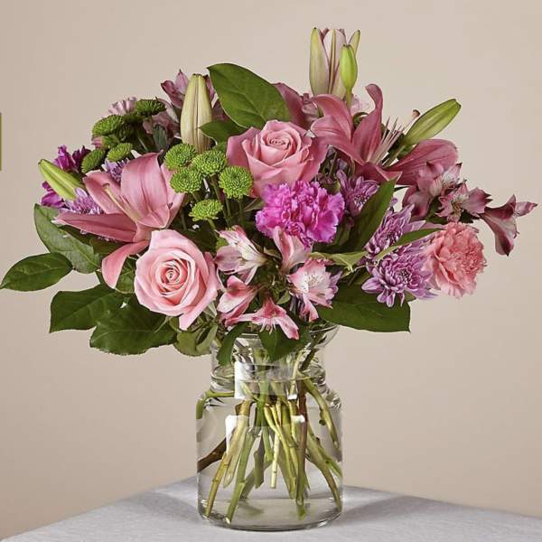 Pink and purple mixed bouquet in a clear glass vase