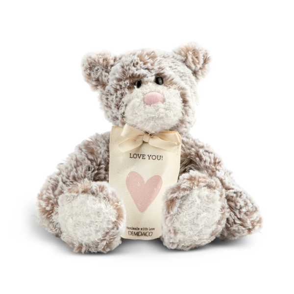 Plush teddy bear with a ribbon and heart tag