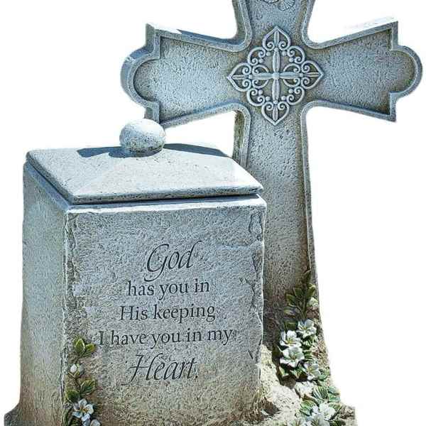 Stone memorial cross with a lidded urn and floral accents