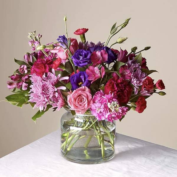 Mixed pink and purple bouquet in a clear glass vase