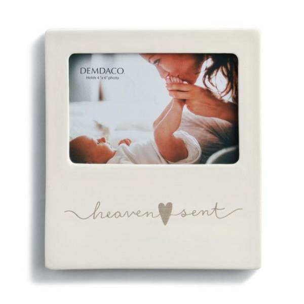Cream photo frame with a baby picture and the words "heaven sent"