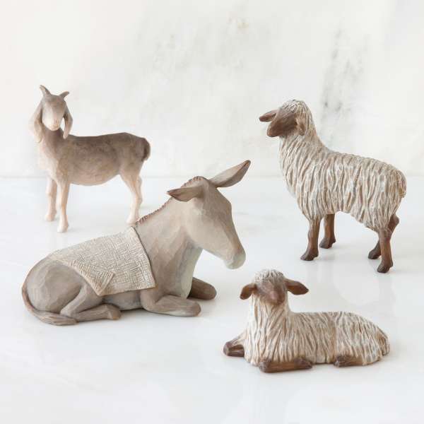 Four carved animal figurines on a white surface