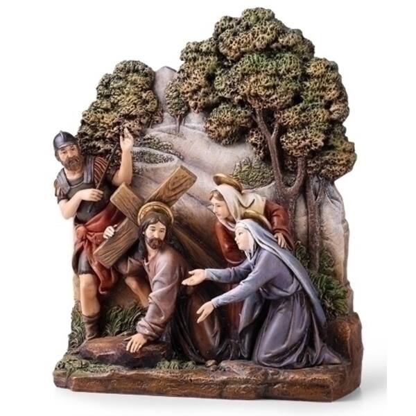 Religious figurine of Jesus carrying a cross with three figures beside him