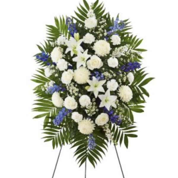 White and blue funeral spray on a standing easel
