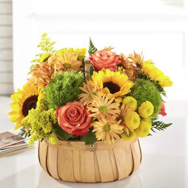 Basket arrangement with sunflowers, roses, and yellow mums