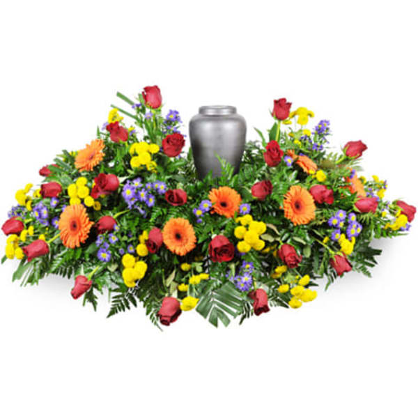 Colorful funeral wreath with a silver urn in the center