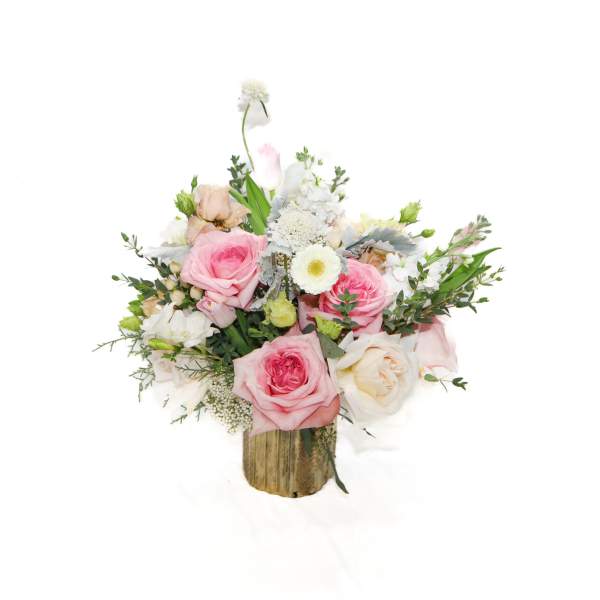 Pink and white rose bouquet in a rustic wooden container