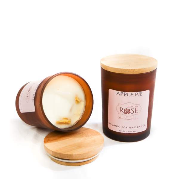 Two apple pie scented candles in amber glass jars with wooden lids