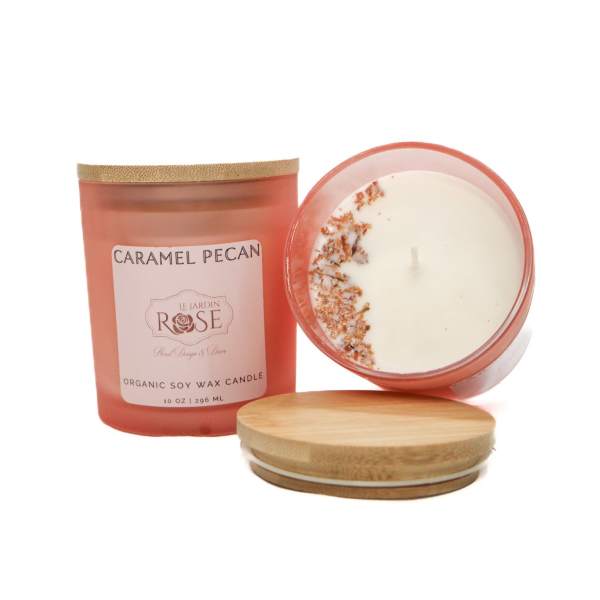 Two caramel pecan candles with wooden lids on a white background
