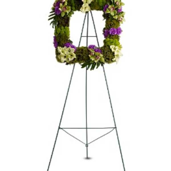 Floral wreath on a metal easel with purple and white flowers