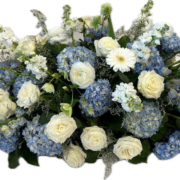 Blue hydrangeas and white roses arranged in a low centerpiece