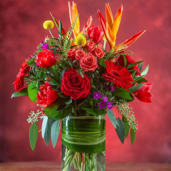 Bouquet of red and orange flowers in a glass vase