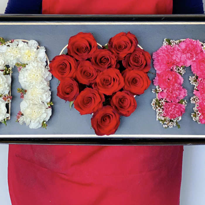 Tray with floral letters in white and pink and a red rose heart