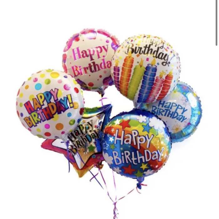 Cluster of colorful birthday balloons with printed messages