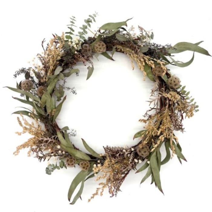 Dried floral wreath with muted green leaves and tan seed pods