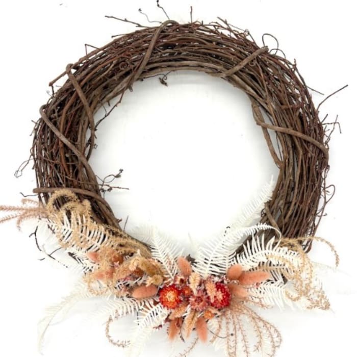 Rustic grapevine wreath with dried flowers and pale fern accents