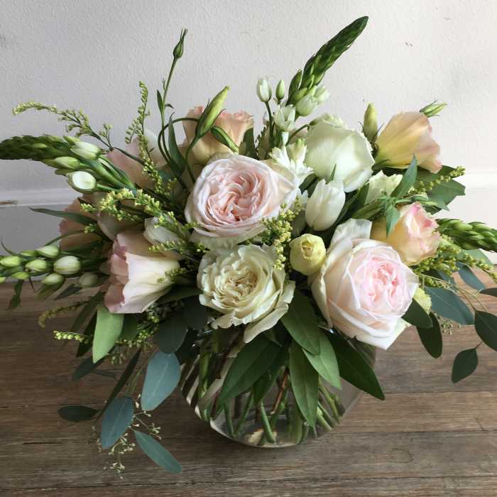 Blush and white rose bouquet in a clear glass vase