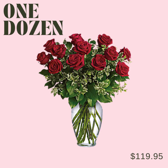 Dozen red roses in a clear glass vase