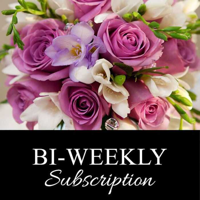 Bouquet of pink and white flowers with purple roses