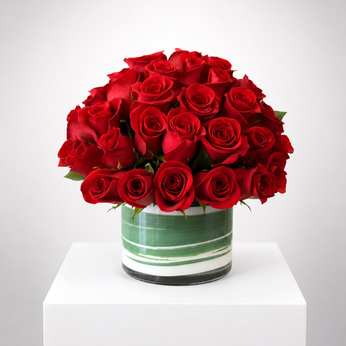 Red rose bouquet in a striped glass vase
