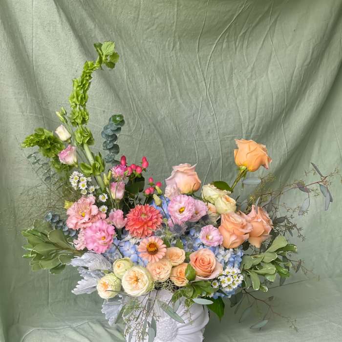 Mixed pastel bouquet in a white ceramic vase