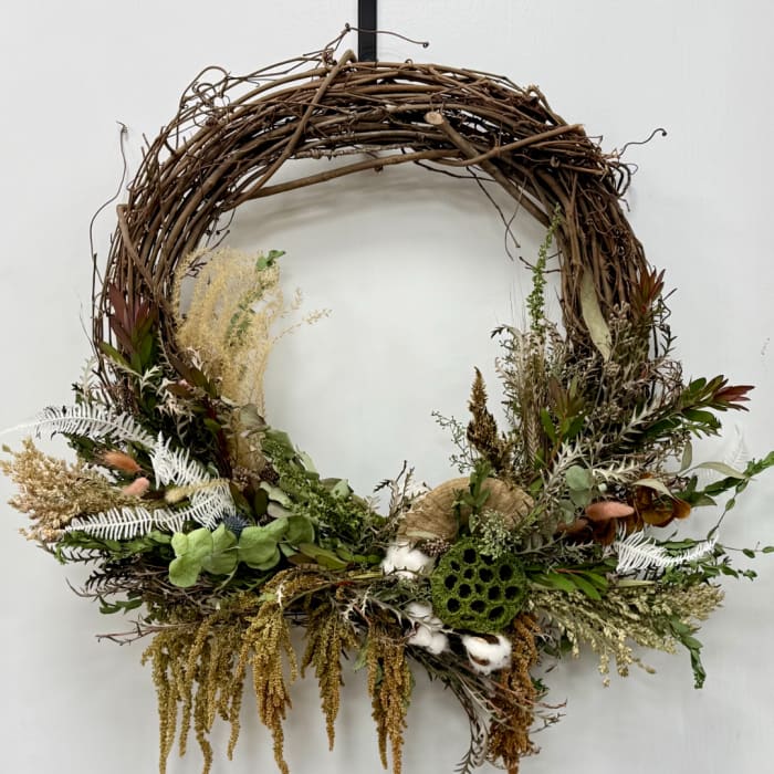 Rustic grapevine wreath with dried botanicals and cotton accents