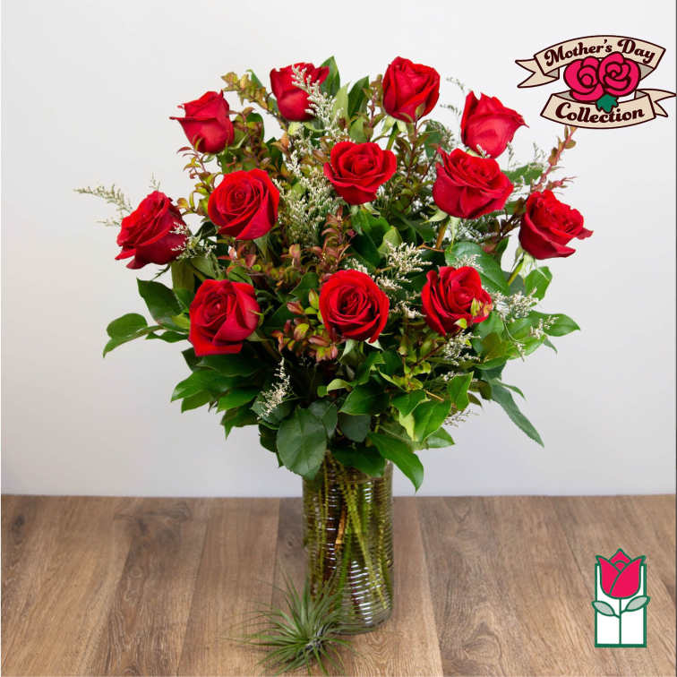 Red roses arranged in a clear glass vase