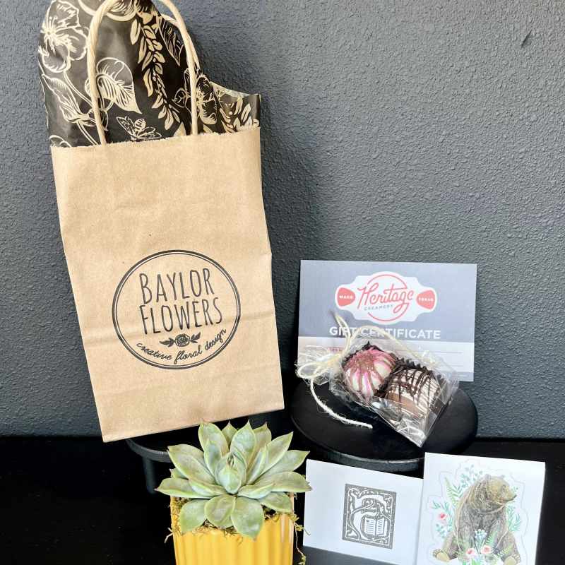Gift set with a succulent, chocolates, and a gift certificate in branded packaging