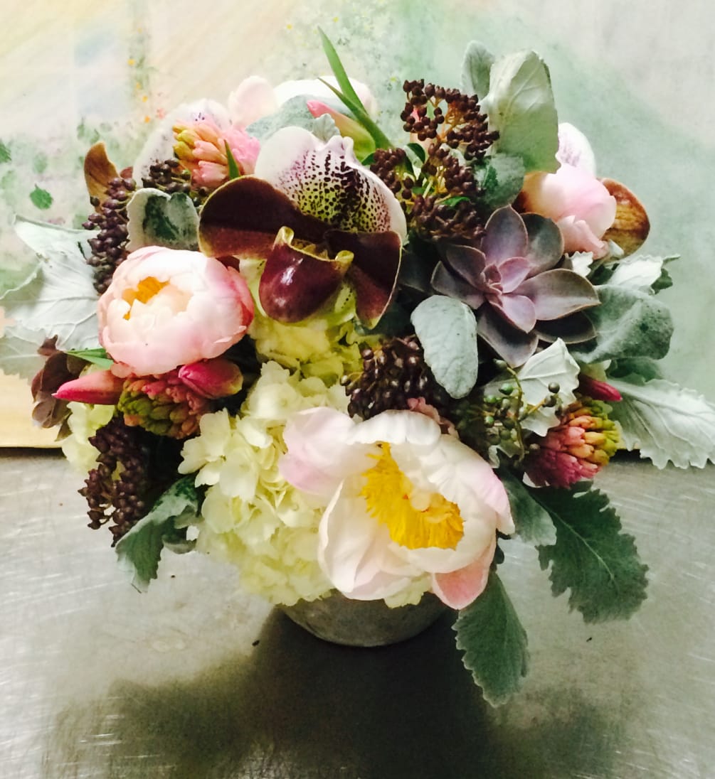 Peonies ,lady sleepers orchids ,ranunculus,tulips, whit hydrangea in a cement vase