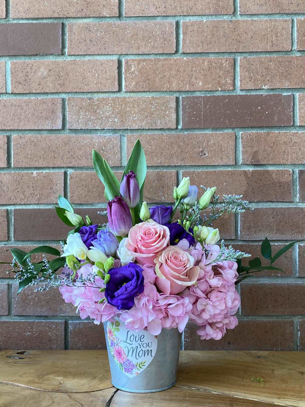 A charming planter full of fresh cut flowers! Sweet hydrangias, tullips and