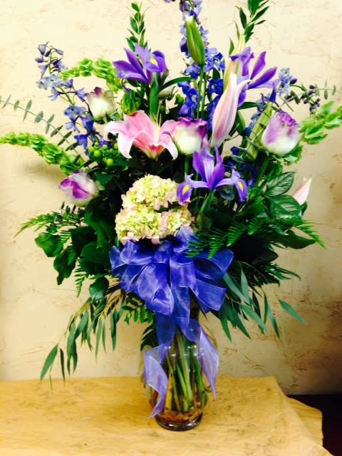 A beautiful hue of blues and purple with pink lilies, hydrangea, blur