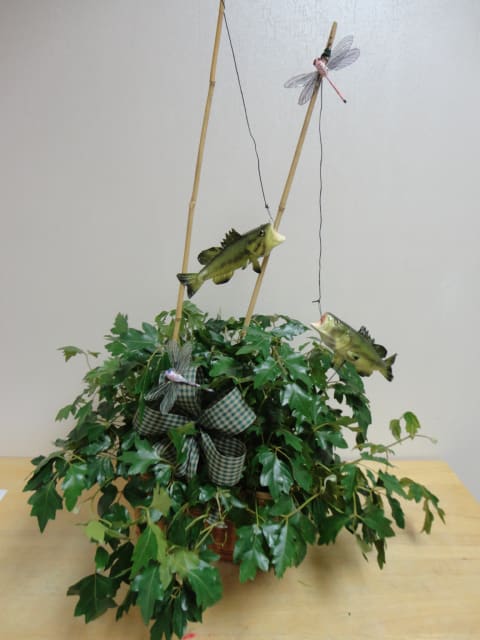 Green plant with accents of fishing poles and fish.