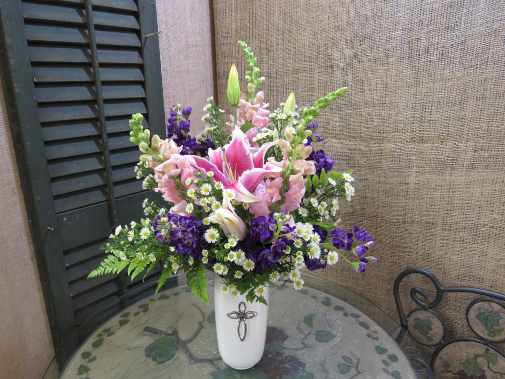 A beautiful bouquet is complimented by a keepsake cross vase. 