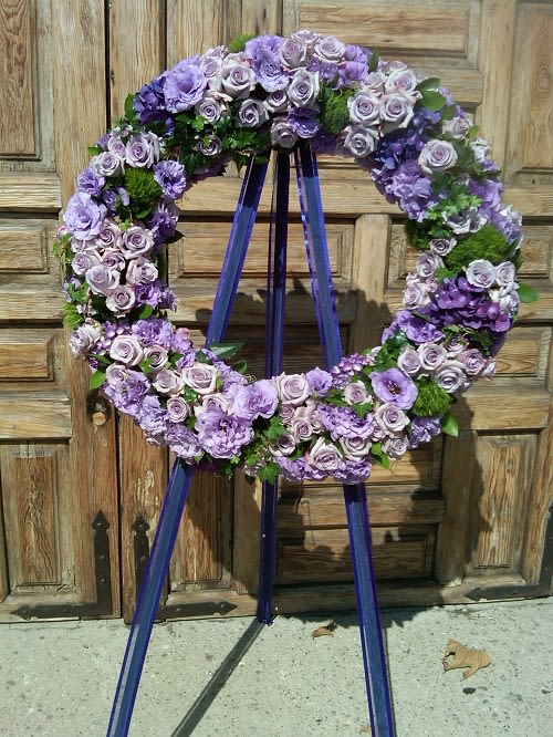 This Gorgeous purple and lavender funeral wreath is sure to pay homage