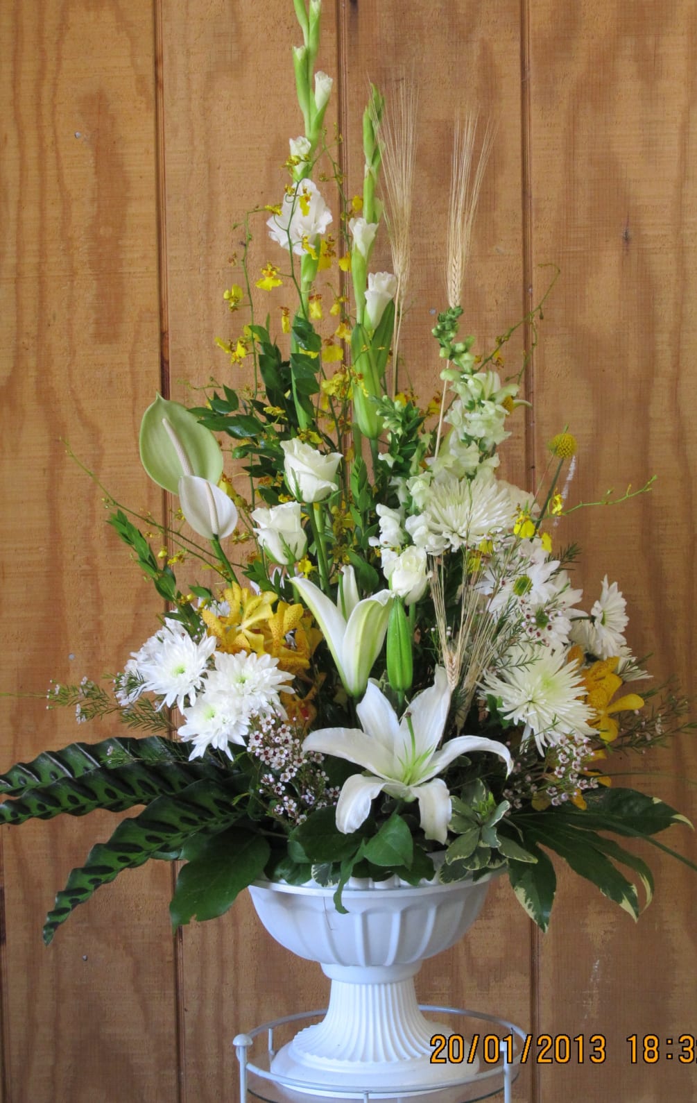 Tastefully collection of tropical greenery, white oriental lilys, gladilolas, mums , anthirium