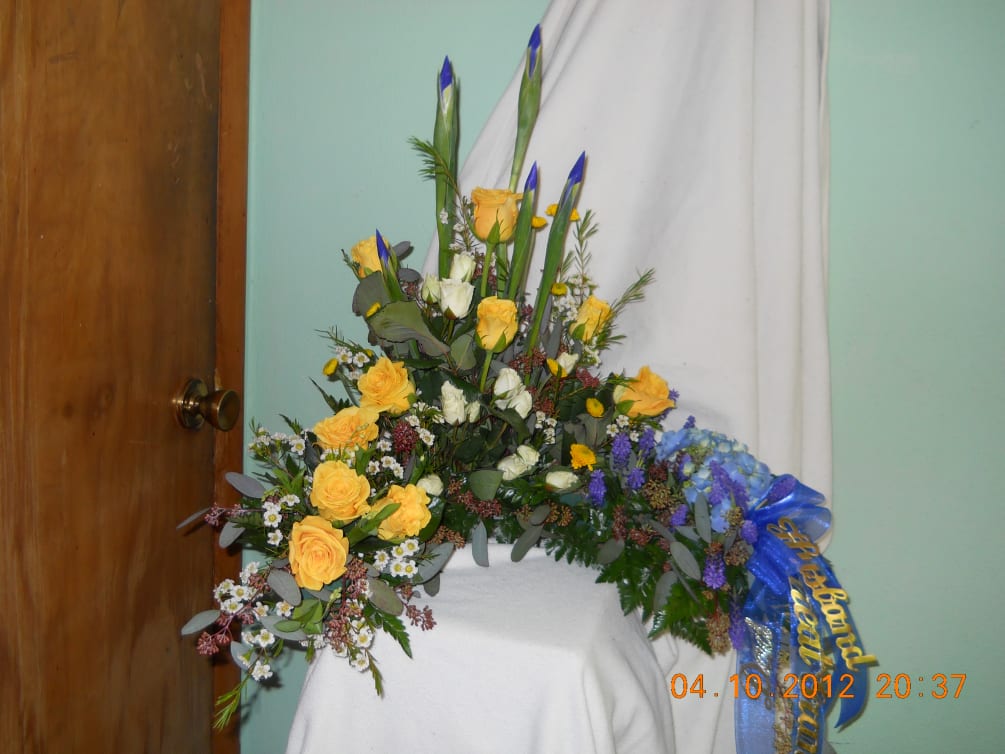 yellow roses, blue iris, blue hydrangea, white wax flowers