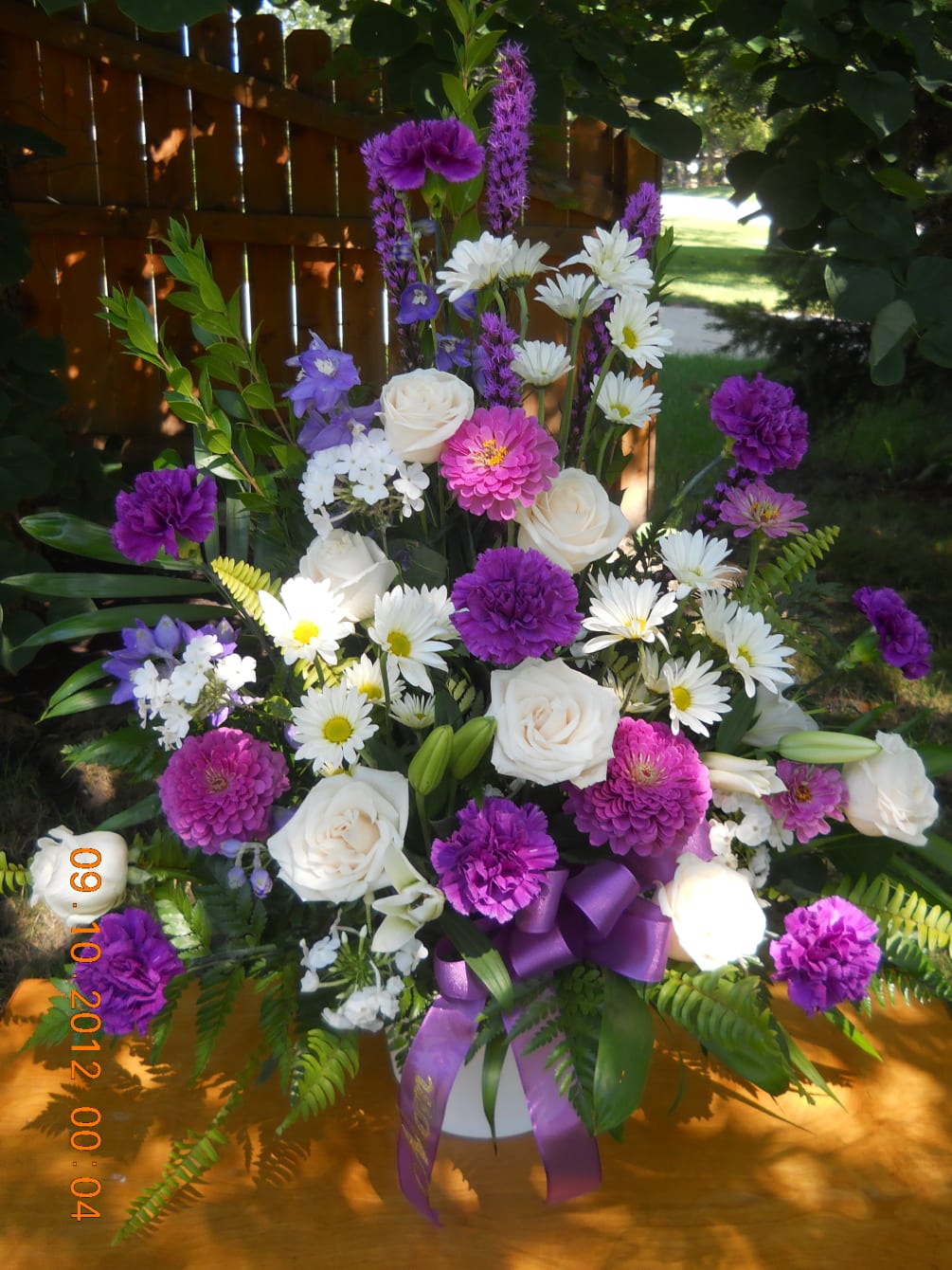 purple liatris, carnations, zinias, white roses and daisys