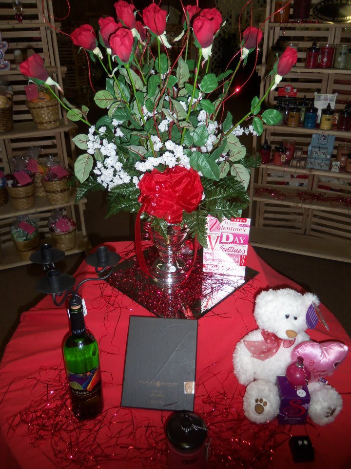1 dz red roses in vase with fiiler &amp; greens with bow.