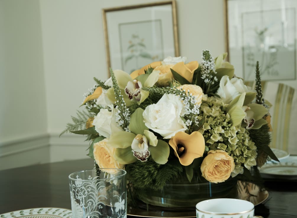 Elegant centerpiece feutiring Yellow callas, yellow roses , white roses, green hydrangeas