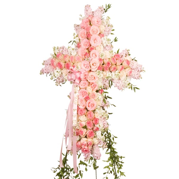 This beautiful pink cross features roses and pastel stock to create a