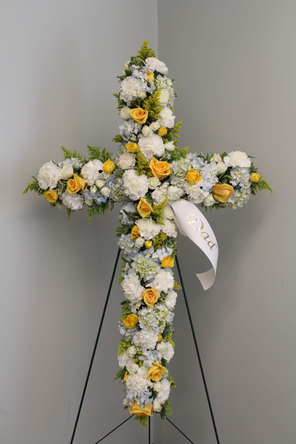 A beautiful yellow assorted floral cross that makes a visually stunning presentation.