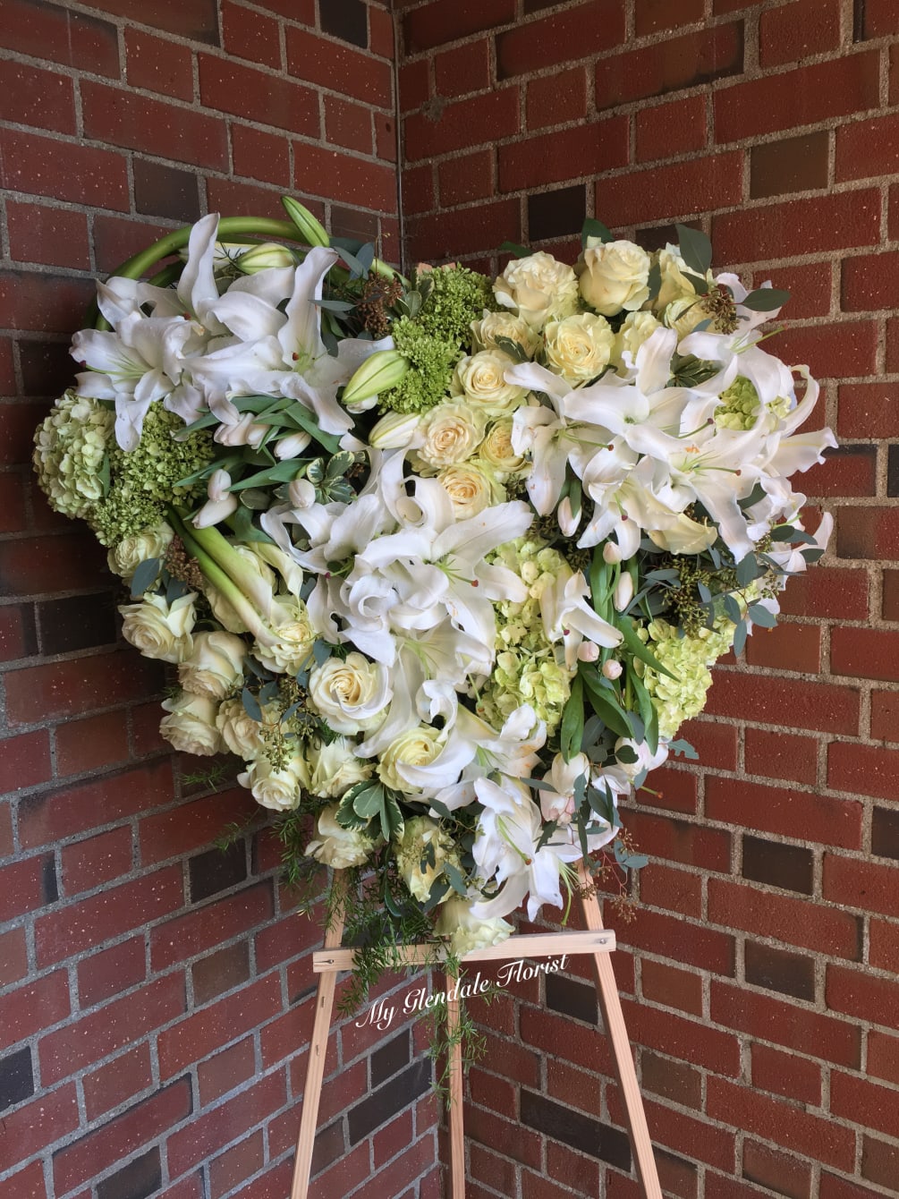 This unique design consists of lilies, callas, roses and hydrangeas. 