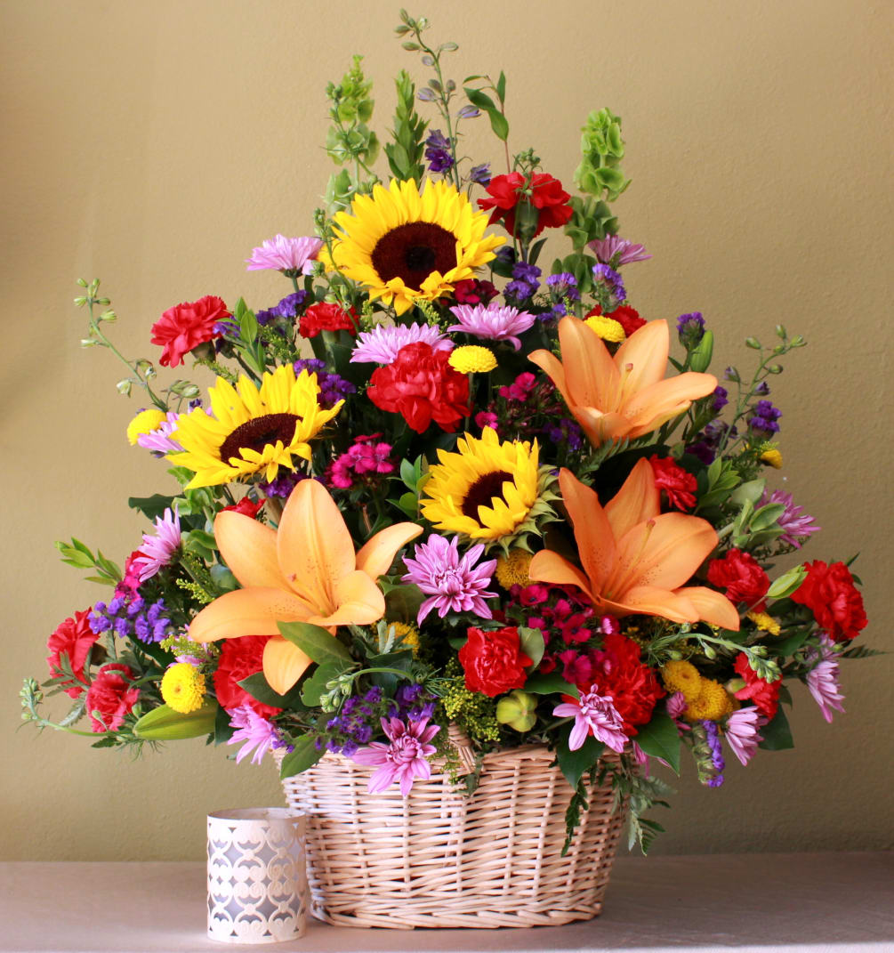 Big basket arrangement of sunflowers, bells of Ireland  and red carnations