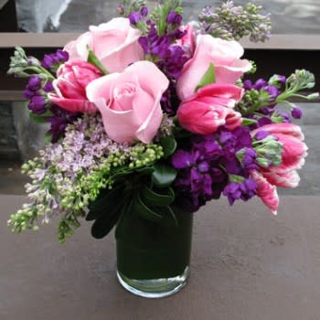 A cute arrangement with roses, tulips and stalk