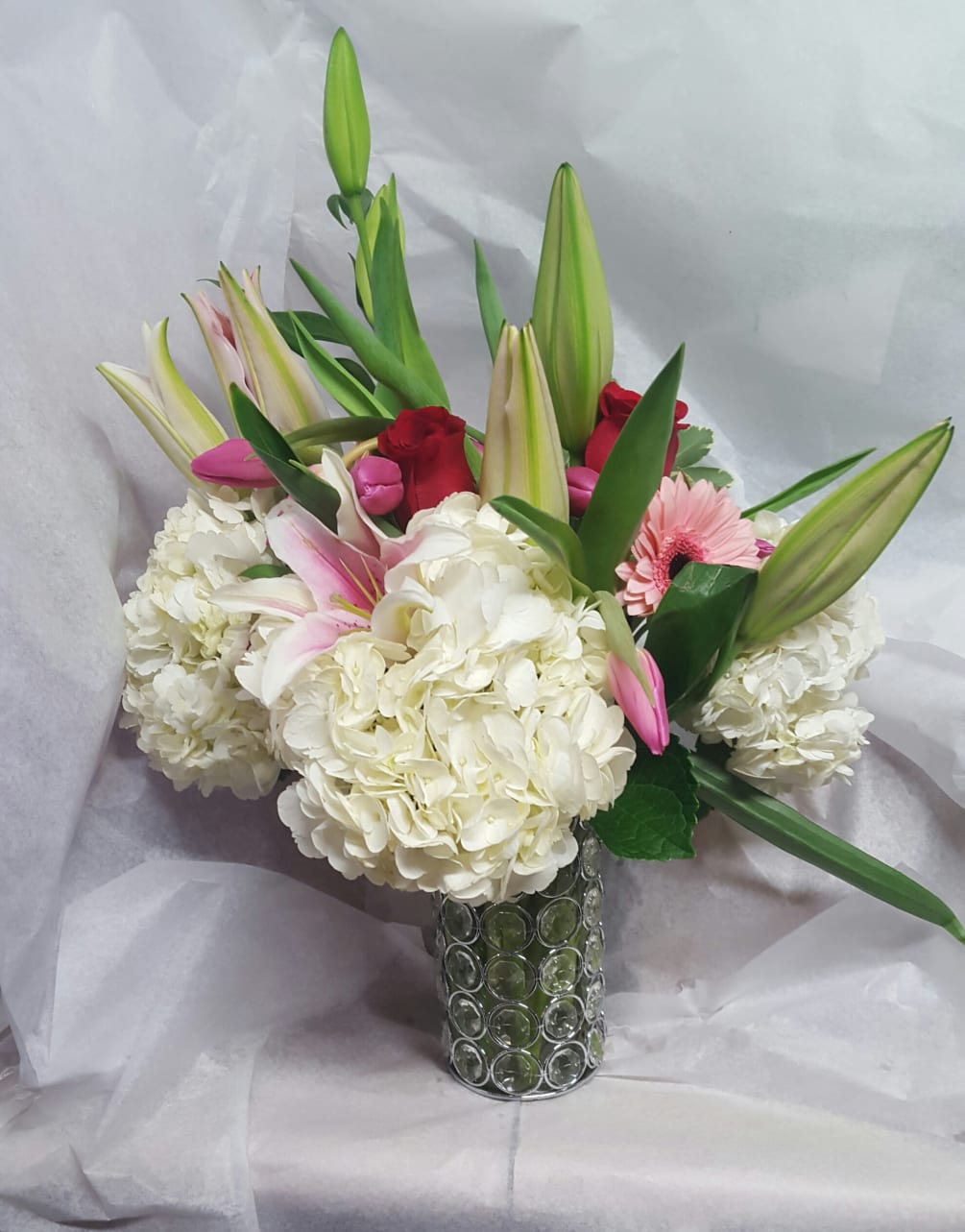 This elegant bouquet features stunning white hydrangea star gazer lilies, tulips and