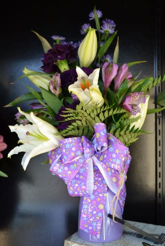 White Lily, Alstro, Carnations and more in a purple and a beautiful
